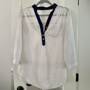Delicate in nature yet bold in style. Ladie's white polka blue dots blouse
